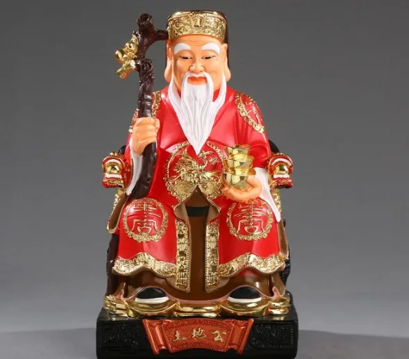 Alt: Tượng Thần Tài cầm thỏi vàng, biểu tượng cho sự giàu có và thịnh vượng